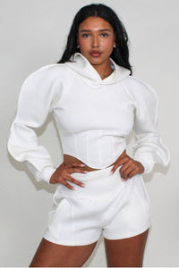  Contemporary casual white two-piece set featuring a cropped hoodie with dramatic sleeves and sleek high-rise shorts.
