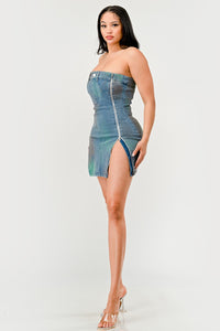 Denim Rush Hour Dress | Model wearing a strapless denim mini dress featuring a structured bust design, zipper accents on both sides creating adjustable slits, and subtle distressed details for a chic and edgy look - Rêves dorés