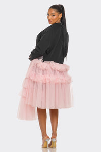 Oversized Tulle Blazer Dress Black and Pink
Model wearing a bold and avant-garde blazer dress in black, featuring a plunging neckline, oversized silhouette, and pastel pink ruffled tulle accents cascading asymmetrically. A statement piece blending edgy tailoring with whimsical femininity, styled with clear heels for a modern touch. - Rêve Dorés