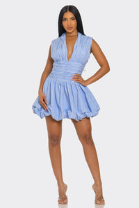 Model wearing Azure Ruched Bubble Mini Dress with deep V neckline and bubble hem perfect for summer and vacation